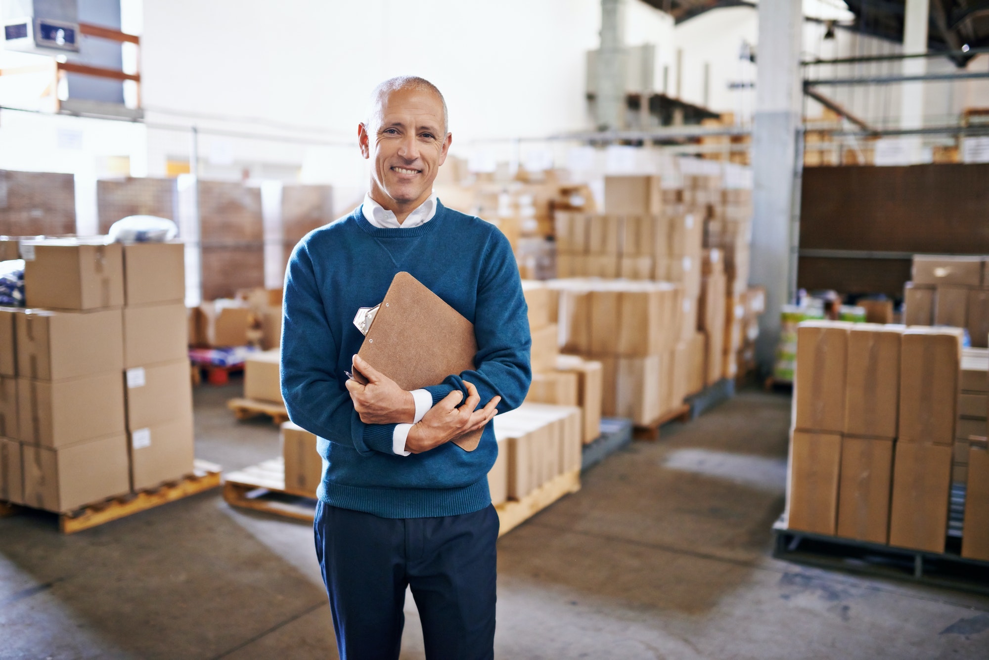 Let me handle the logistics. Portrait of a mature man standing in a distribution warehouse.